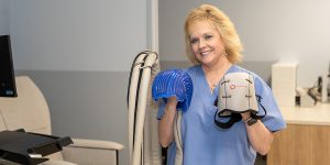 Profesional aplicando tratamiento de frío localizado sobre el cuero cabelludo de un paciente